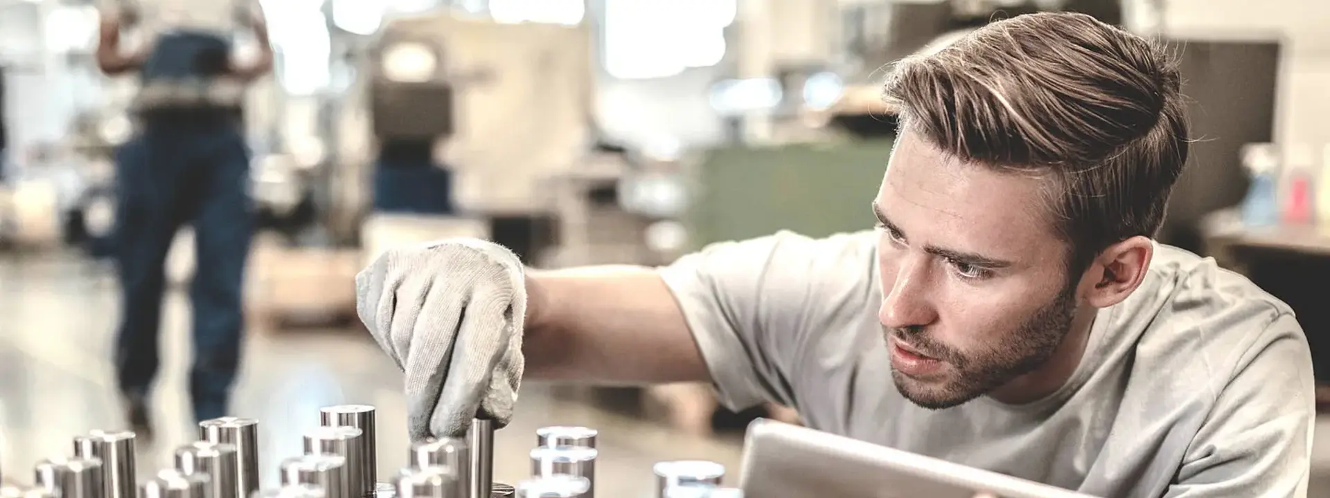 A worker checks metal parts